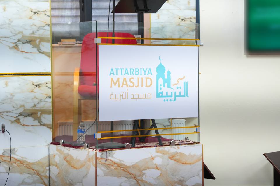The minbar, its front carrying the masjid's name and logo