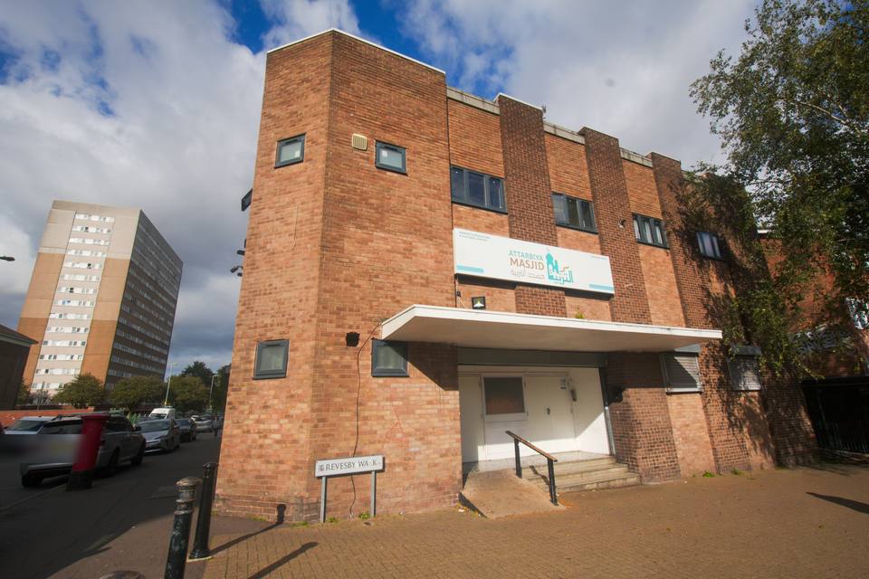 Attarbiya Masjid on Revesby Walk: a three-storey red-brick building with the masjid's sign above the entrance